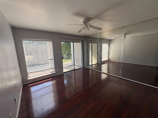 2822 S Bartell Dr Unit 22, Houston, TX 77054 - spare room with a ceiling fan, a textured ceiling, wood-type flooring, and baseboards