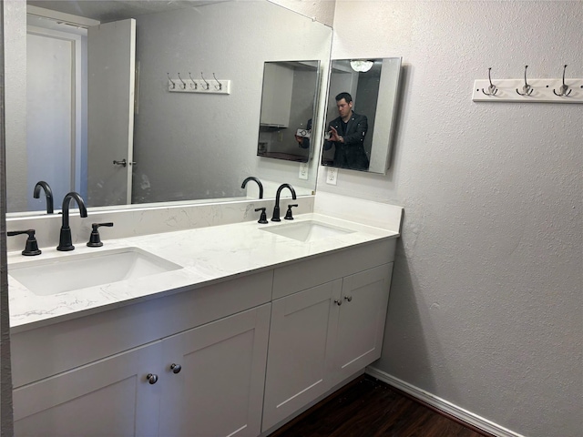 2822 S Bartell Dr Unit 22, Houston, TX 77054 - bathroom with a textured wall, wood finished floors, double vanity, and baseboards