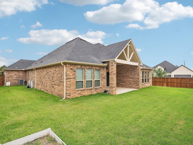 27419 Haywood Ln, Katy, TX 77494 - back of property with central air condition unit, brick siding, a patio, and roof with shingles