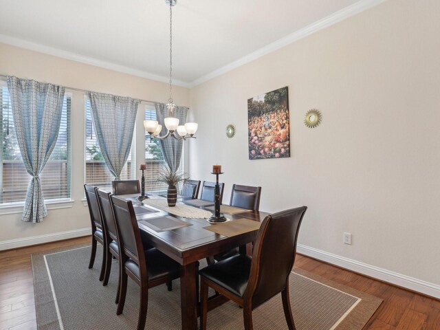 27419 Haywood Ln, Katy, TX 77494 - dining space with a chandelier, baseboards, dark wood-type flooring, and crown molding