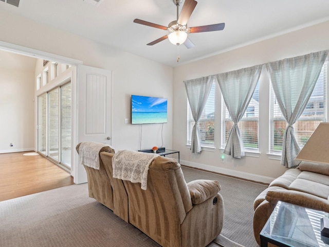 27419 Haywood Ln, Katy, TX 77494 - living area featuring a ceiling fan, baseboards, and light carpet