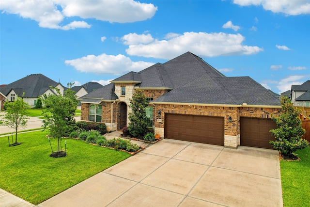27419 Haywood Ln, Katy, TX 77494 - french country inspired facade with a garage, a front lawn, concrete driveway, roof with shingles, and brick siding