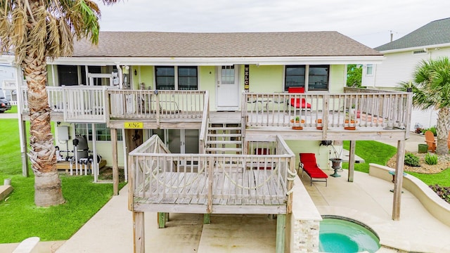 1417 8th St, San Leon, TX 77539 - rear view of property with roof with shingles, an outdoor pool, stairs, and a patio