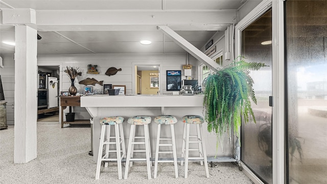 1417 8th St, San Leon, TX 77539 - kitchen with speckle patterned floor, oven, recessed lighting, and a kitchen bar