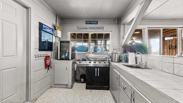 1417 8th St, San Leon, TX 77539 - kitchen featuring a sink, tile countertops, and dark speckled floor