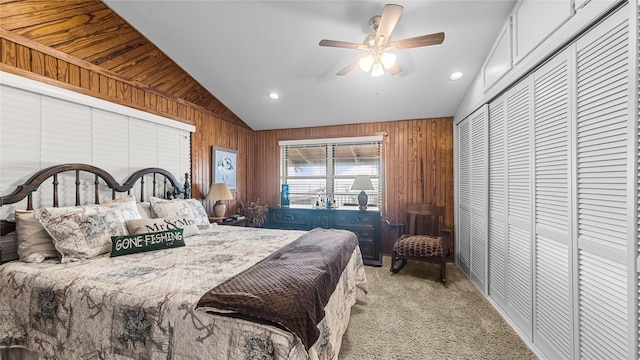 1417 8th St, San Leon, TX 77539 - bedroom with vaulted ceiling, wood walls, light colored carpet, a closet, and ceiling fan