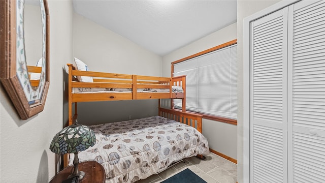 1417 8th St, San Leon, TX 77539 - bedroom with vaulted ceiling, a closet, and a textured ceiling