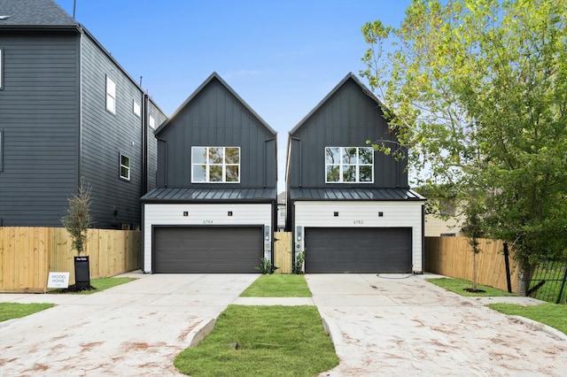 6705 Del Rio St, Houston, TX 77021 - modern inspired farmhouse featuring a garage, driveway, board and batten siding, and a standing seam roof