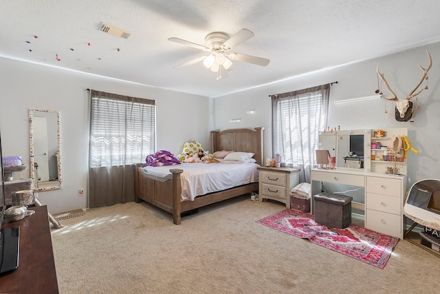 9219 Sendera Dr, Magnolia, TX 77354 - bedroom with multiple windows, carpet flooring, and ceiling fan