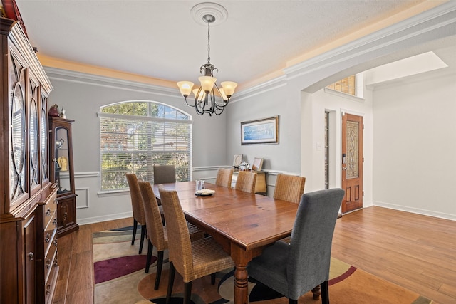 15106 Aragon Green Dr, Cypress, TX 77433 - dining area featuring a chandelier, wood finished floors, and baseboards