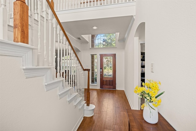 15106 Aragon Green Dr, Cypress, TX 77433 - entryway featuring baseboards, a high ceiling, arched walkways, hardwood / wood-style flooring, and stairway