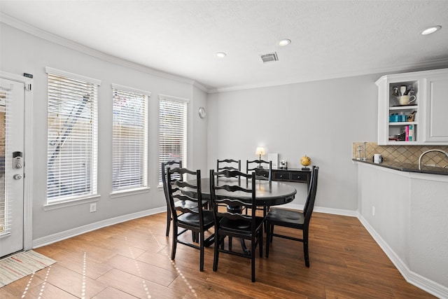 15106 Aragon Green Dr, Cypress, TX 77433 - dining area featuring recessed lighting, crown molding, wood finished floors, and baseboards