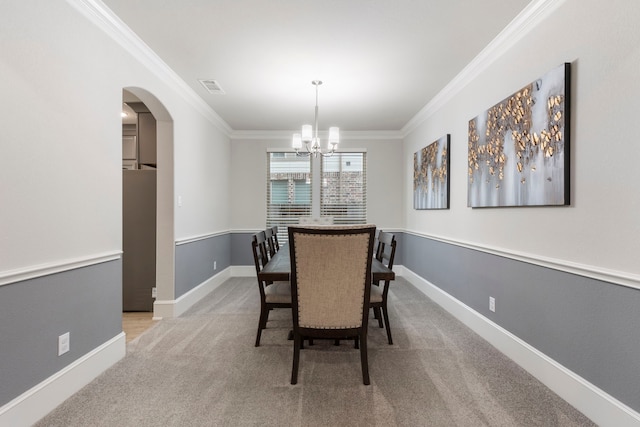 17505 Spice Merlot Ln, Conroe, TX 77302 - dining space featuring crown molding, a chandelier, light colored carpet, arched walkways, and baseboards