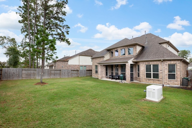 17505 Spice Merlot Ln, Conroe, TX 77302 - rear view of property featuring a shingled roof, a patio area, and brick siding