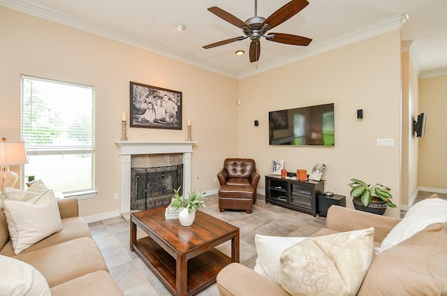 320 Eagle Cv, Hempstead, TX 77445 - living area with crown molding, a tiled fireplace, ceiling fan, light tile patterned flooring, and baseboards
