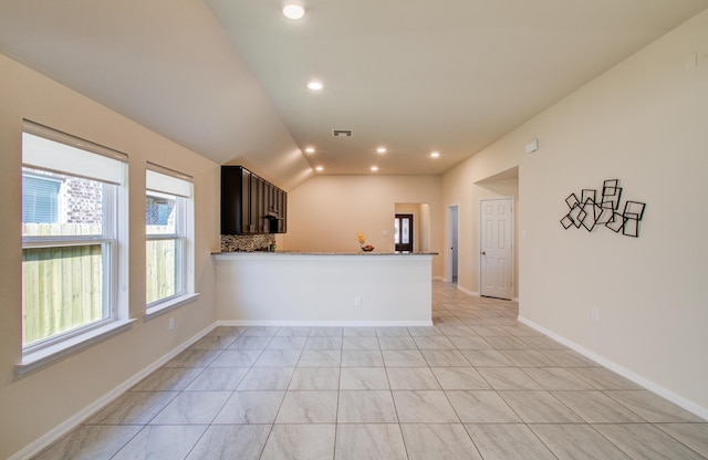 20615 Footstep Path, Katy, TX 77449 - kitchen with recessed lighting, vaulted ceiling, light stone countertops, baseboards, and a peninsula