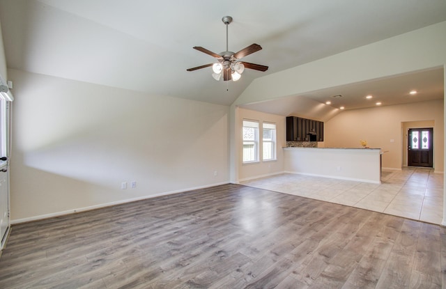 20615 Footstep Path, Katy, TX 77449 - unfurnished living room featuring lofted ceiling, ceiling fan, light wood-type flooring, baseboards, and recessed lighting