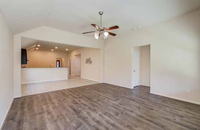 20615 Footstep Path, Katy, TX 77449 - unfurnished living room with lofted ceiling, wood finished floors, a ceiling fan, baseboards, and recessed lighting