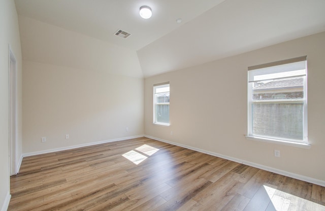 20615 Footstep Path, Katy, TX 77449 - empty room featuring light wood-type flooring, lofted ceiling, and baseboards