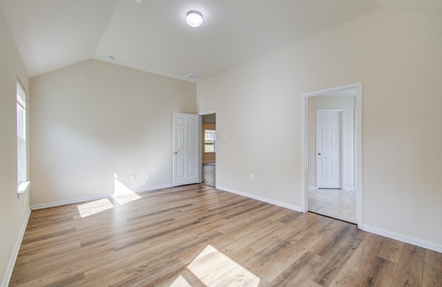 20615 Footstep Path, Katy, TX 77449 - unfurnished bedroom featuring vaulted ceiling, light wood finished floors, and baseboards