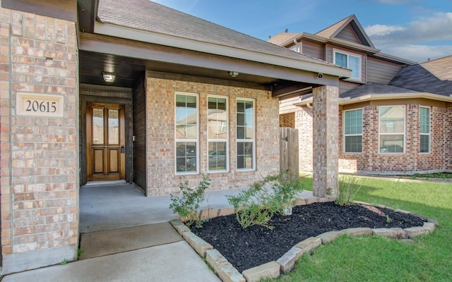 20615 Footstep Path, Katy, TX 77449 - doorway to property with brick siding, roof with shingles, and a yard