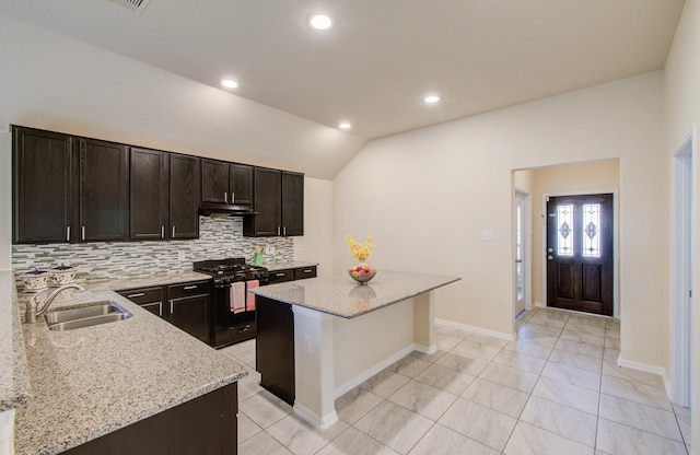 20615 Footstep Path, Katy, TX 77449 - kitchen with black gas range, a sink, tasteful backsplash, under cabinet range hood, and vaulted ceiling