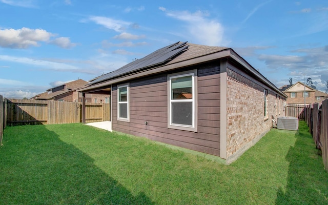 20615 Footstep Path, Katy, TX 77449 - rear view of property featuring cooling unit, roof mounted solar panels, and brick siding