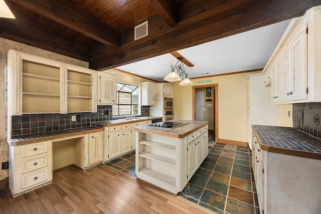 13415 Bayonne Cir, Tomball, TX 77377 - kitchen featuring open shelves, tile counters, backsplash, cream cabinets, and wood ceiling with exposed beams