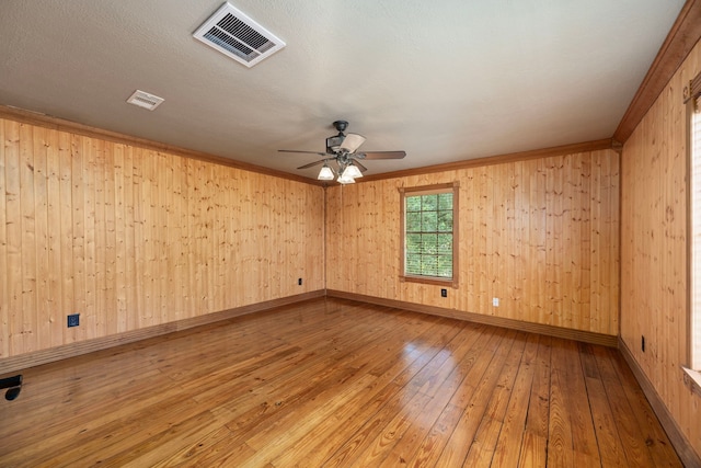 13415 Bayonne Cir, Tomball, TX 77377 - unfurnished room with hardwood / wood-style flooring, a ceiling fan, baseboards, ornamental molding, and wooden walls