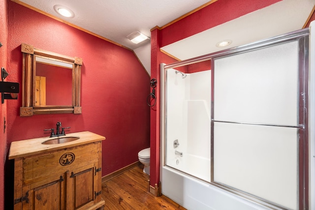 13415 Bayonne Cir, Tomball, TX 77377 - bathroom featuring vanity, toilet, wood finished floors, shower / bath combination with glass door, and vaulted ceiling