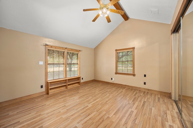 13415 Bayonne Cir, Tomball, TX 77377 - empty room featuring healthy amount of natural light, beamed ceiling, light wood-style floors, a ceiling fan, and baseboards