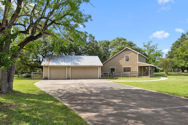 13415 Bayonne Cir, Tomball, TX 77377 - view of front of house with an outdoor structure, a detached garage, and metal roof