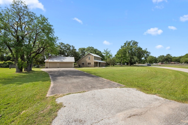 13415 Bayonne Cir, Tomball, TX 77377 - view of front of home with a front lawn, a detached garage, an outdoor structure, and metal roof