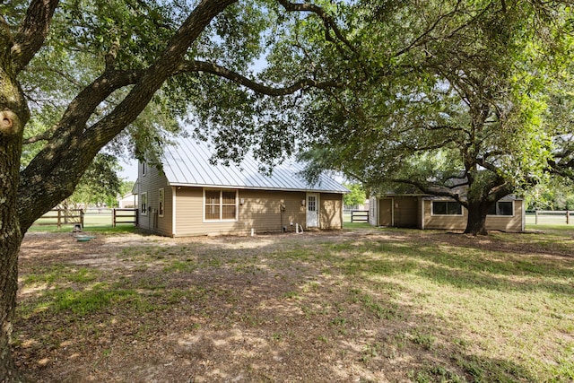 13415 Bayonne Cir, Tomball, TX 77377 - back of house with an outbuilding and metal roof