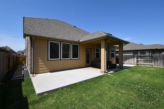 back of property featuring roof with shingles and a patio