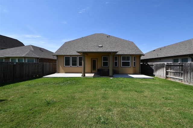 rear view of house featuring a patio and roof with shingles