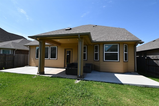 back of house with a patio and roof with shingles