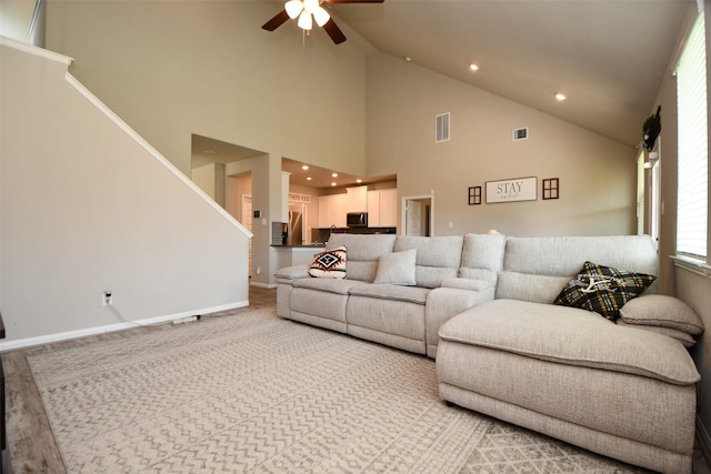 living room featuring ceiling fan, recessed lighting, high vaulted ceiling, stairway, and baseboards