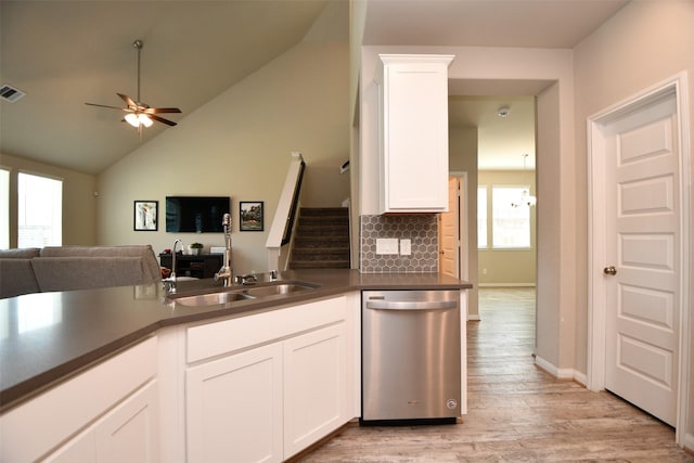 kitchen with stainless steel dishwasher, healthy amount of natural light, open floor plan, a ceiling fan, and lofted ceiling