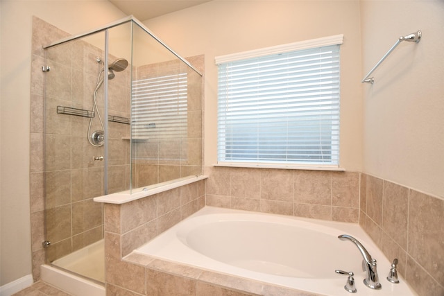 full bath with a shower stall and a garden tub