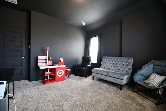 sitting room with carpet flooring and vaulted ceiling