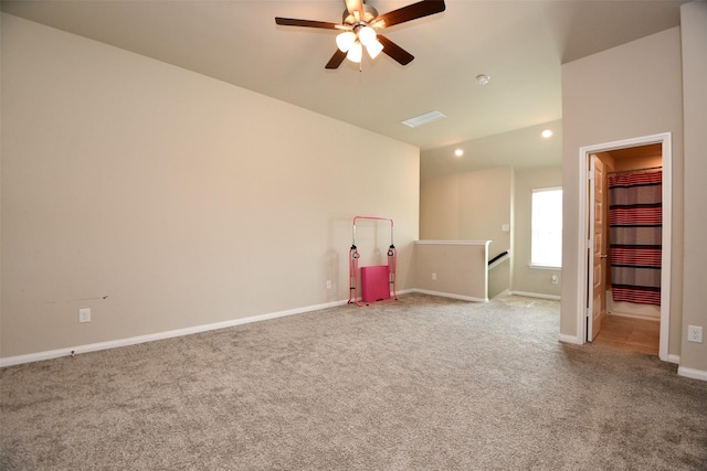 carpeted spare room with a ceiling fan, baseboards, recessed lighting, and vaulted ceiling