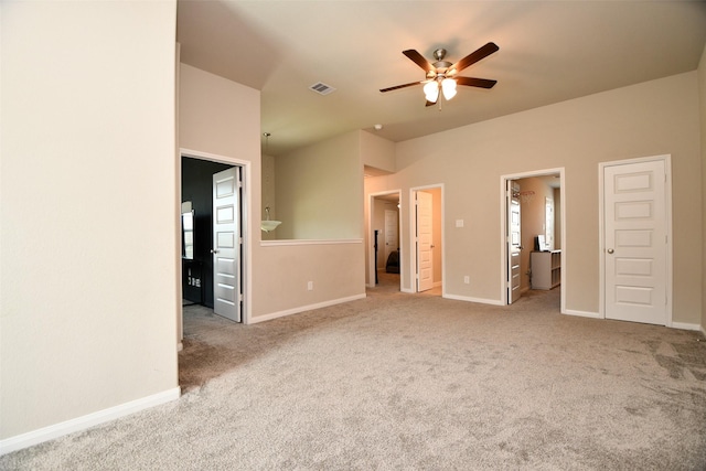 unfurnished bedroom with carpet floors, baseboards, and ensuite bath