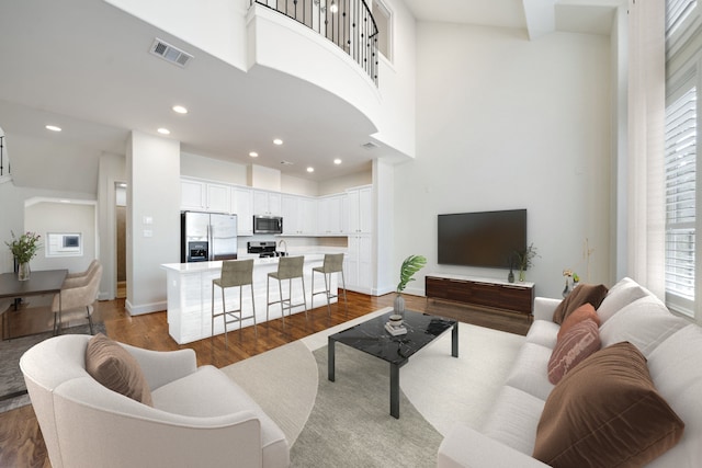 2909 Pease St, Houston, TX 77003 - living room with a high ceiling, dark wood finished floors, recessed lighting, and baseboards