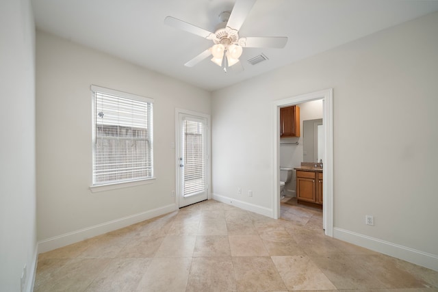 2909 Pease St, Houston, TX 77003 - unfurnished bedroom with access to outside, baseboards, a sink, ensuite bathroom, and a ceiling fan