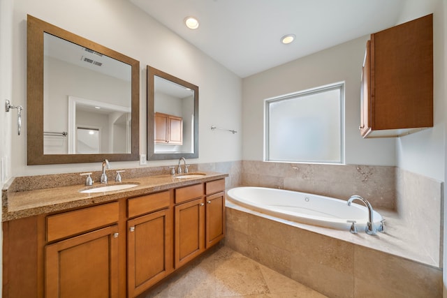 2909 Pease St, Houston, TX 77003 - full bath featuring a garden tub, double vanity, and tile patterned flooring