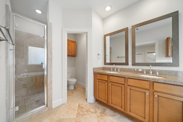 2909 Pease St, Houston, TX 77003 - full bath with a stall shower, toilet, double vanity, and baseboards