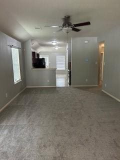 21550 Falvel Misty Dr, Spring, TX 77388 - unfurnished living room with lofted ceiling, baseboards, ceiling fan, plenty of natural light, and carpet