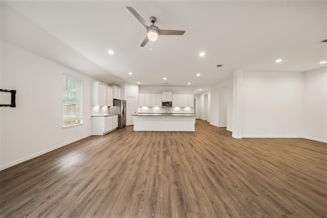 177 Jim Hall Ln, New Waverly, TX 77358 - unfurnished living room with a ceiling fan, recessed lighting, and wood finished floors