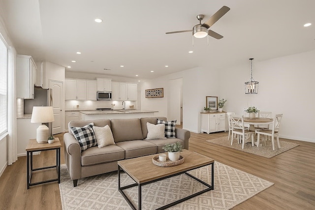 177 Jim Hall Ln, New Waverly, TX 77358 - living area featuring light wood-style floors, a ceiling fan, and recessed lighting
